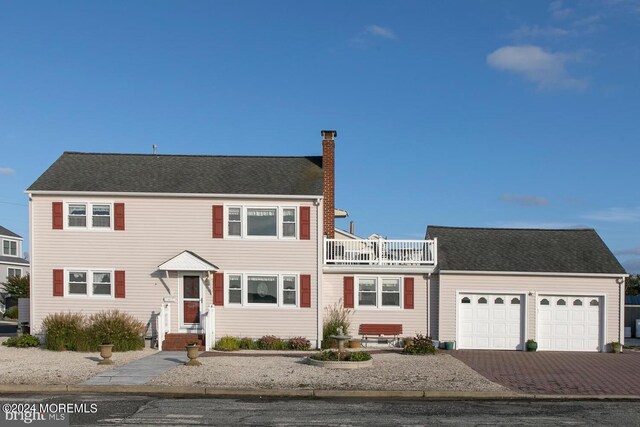 view of front of house with a balcony and a garage