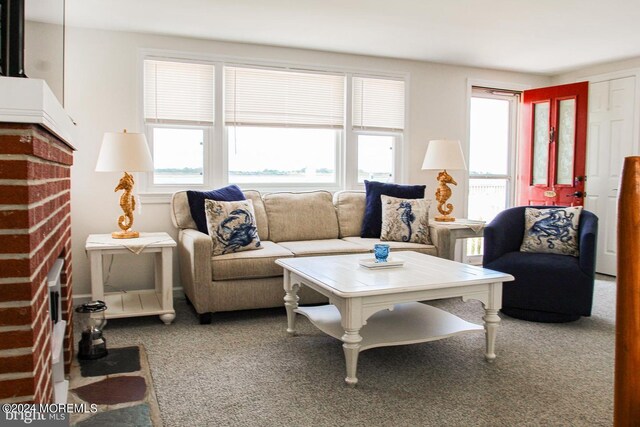 living room with carpet flooring and a brick fireplace