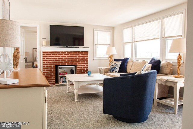 carpeted living room featuring a brick fireplace