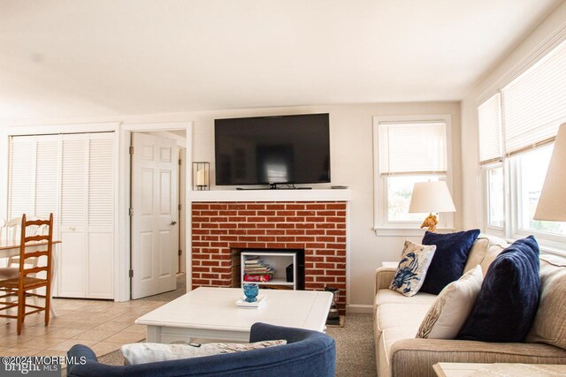 tiled living room with a brick fireplace