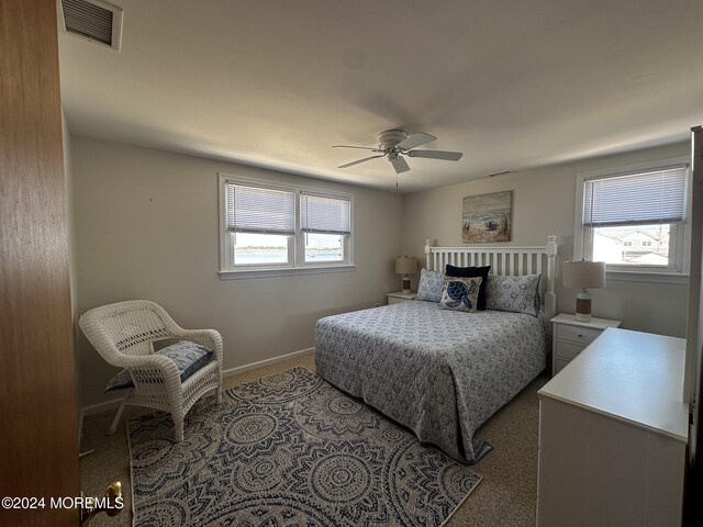 bedroom with ceiling fan and light colored carpet