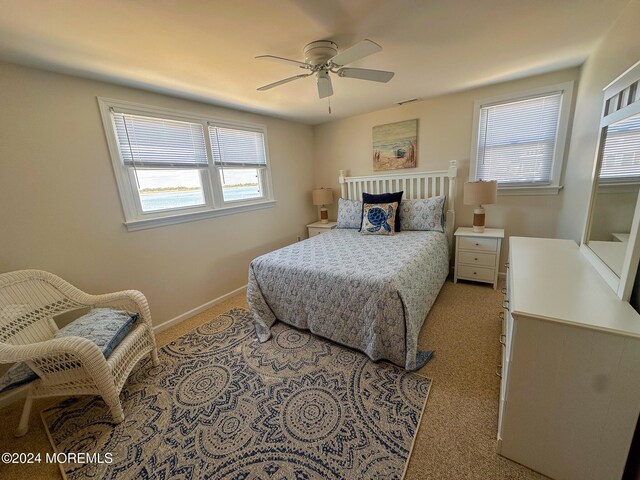 bedroom with ceiling fan and light colored carpet