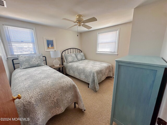 bedroom with ceiling fan and carpet flooring