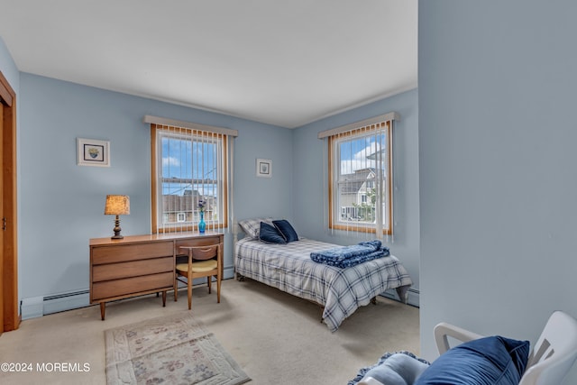 bedroom featuring baseboard heating and carpet