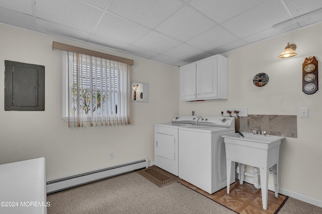 clothes washing area featuring washing machine and dryer, baseboard heating, light parquet floors, cabinets, and electric panel