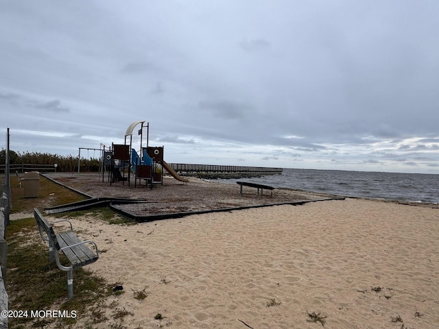 view of playground with a water view