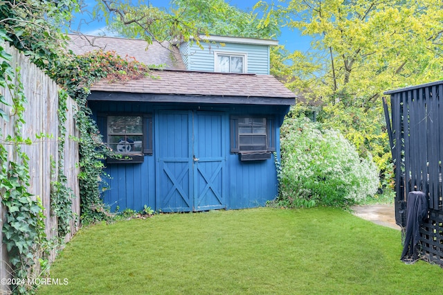 view of outbuilding with a lawn