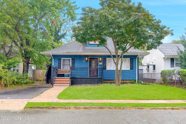 bungalow with a front lawn and a porch