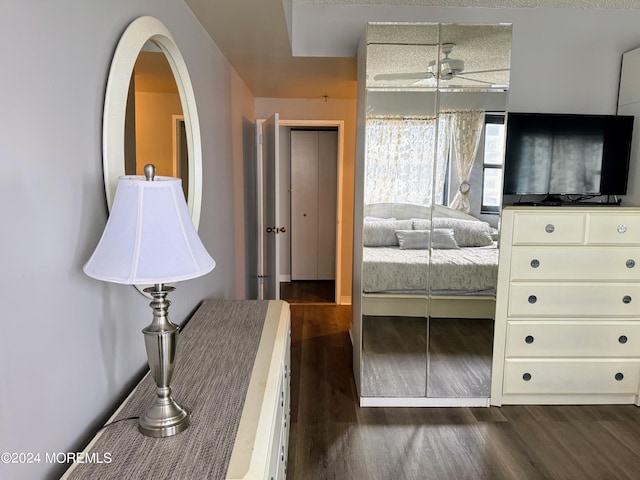 bedroom with dark hardwood / wood-style flooring