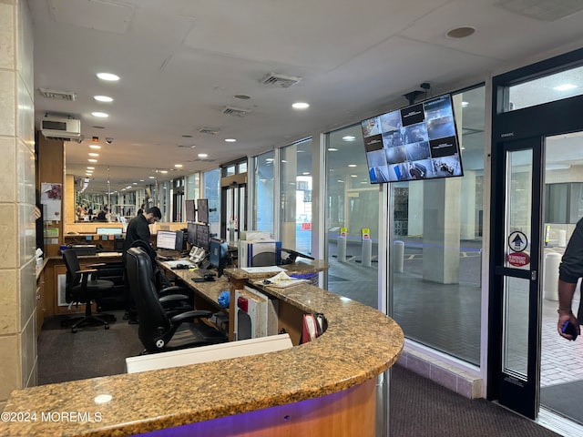 interior space with dark carpet and floor to ceiling windows