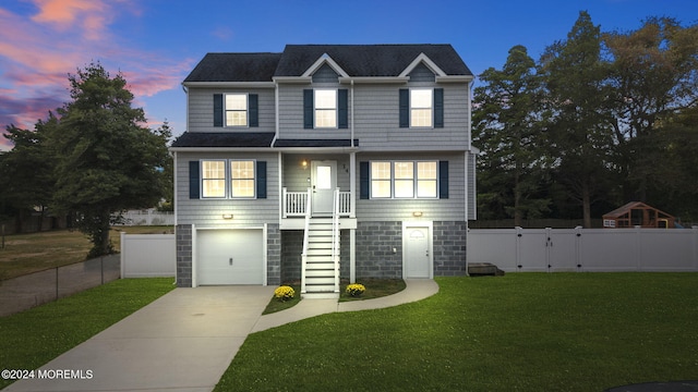 view of front of home featuring a yard and a garage