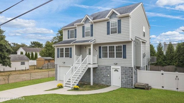 view of front of property with a front yard and central AC unit