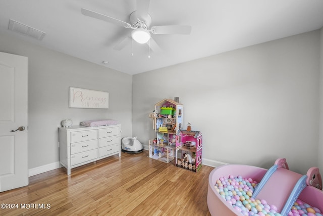 recreation room featuring light hardwood / wood-style floors and ceiling fan