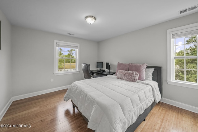 bedroom with wood-type flooring