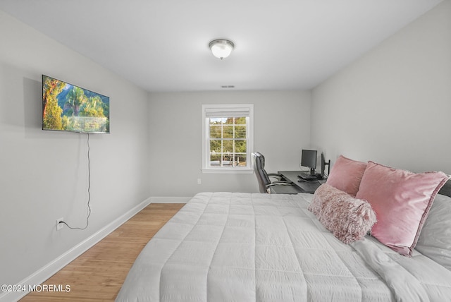 bedroom with hardwood / wood-style flooring