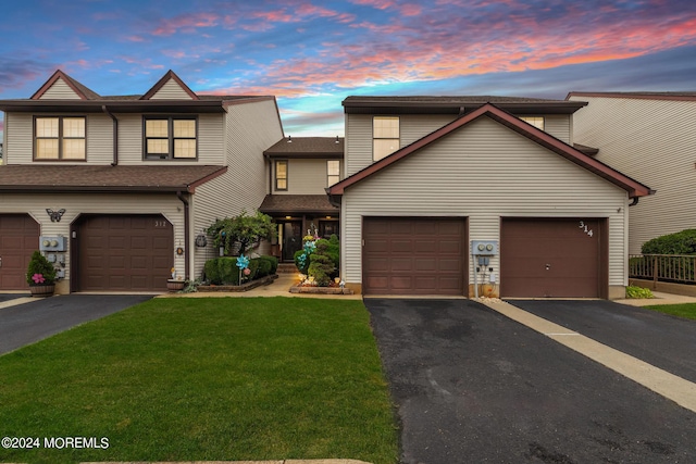 view of front of property featuring a yard and a garage