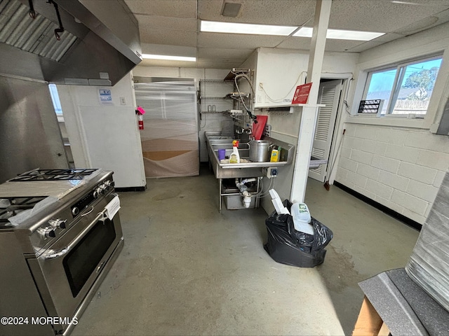 kitchen featuring extractor fan, concrete floors, and stainless steel gas range