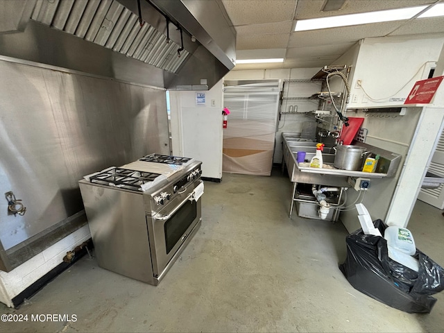 kitchen featuring ventilation hood, high end range, and a paneled ceiling