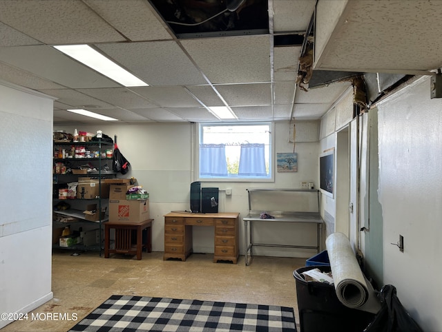 basement featuring a paneled ceiling