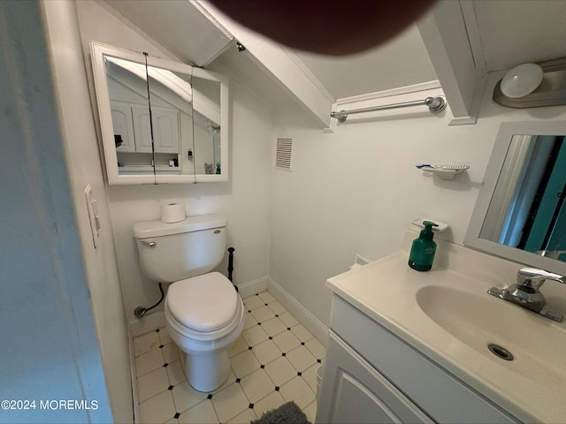 bathroom featuring tile patterned flooring, vanity, and toilet