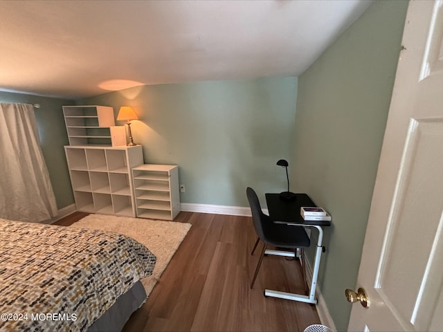 bedroom with dark hardwood / wood-style floors