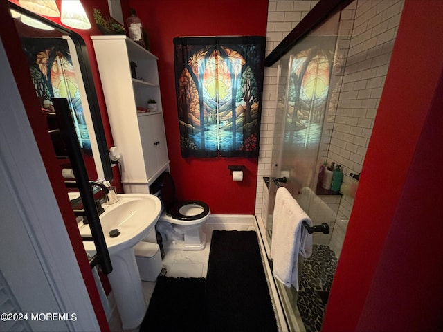 bathroom with tile patterned flooring, toilet, and a shower with shower door