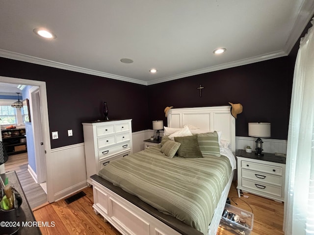 bedroom featuring light hardwood / wood-style flooring and ornamental molding