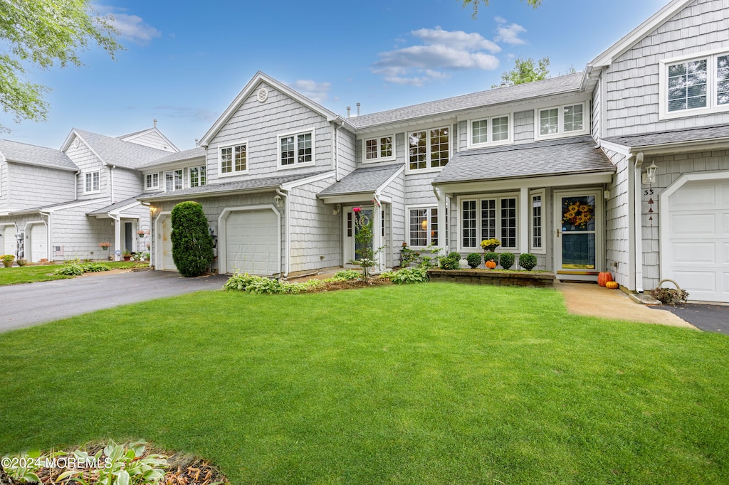 view of front of property featuring a garage and a front lawn