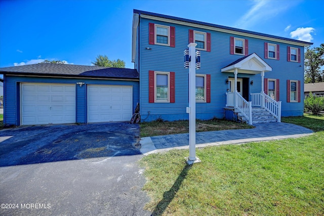 view of front facade with a garage and a front lawn