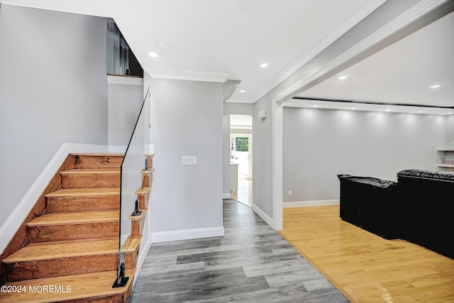 entrance foyer featuring ornamental molding and hardwood / wood-style flooring