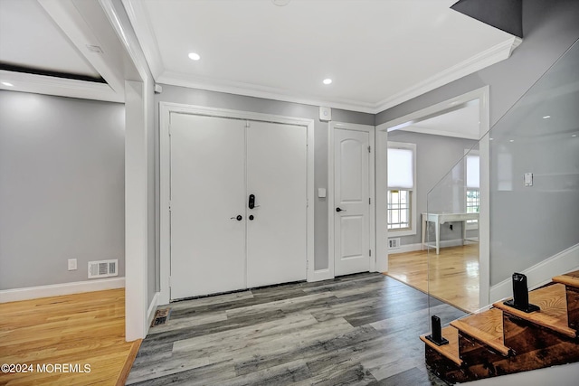 entrance foyer featuring light wood-type flooring and crown molding