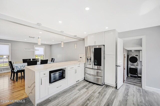 kitchen with pendant lighting, light wood-type flooring, black microwave, stainless steel refrigerator with ice dispenser, and white cabinetry