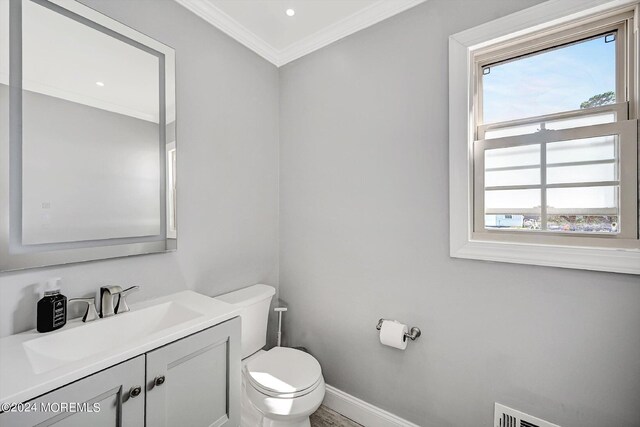 bathroom featuring crown molding, vanity, and toilet