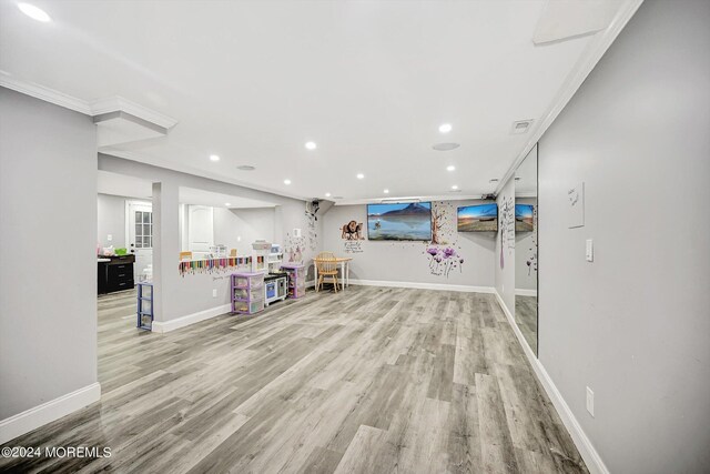 interior space with light hardwood / wood-style floors and crown molding