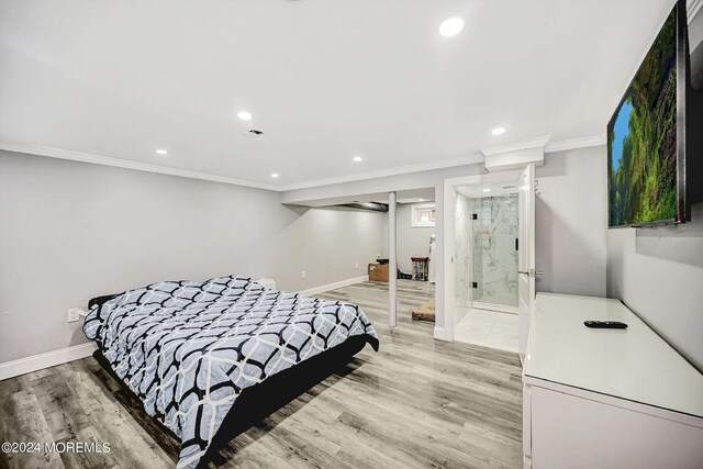 bedroom featuring wood-type flooring, connected bathroom, and ornamental molding