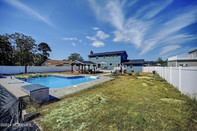 view of swimming pool featuring a lawn, a patio, and a gazebo