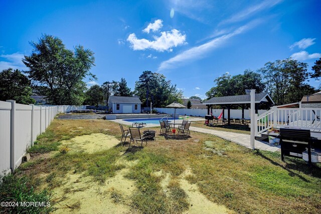 view of yard with a fenced in pool, an outdoor structure, a patio area, and a gazebo