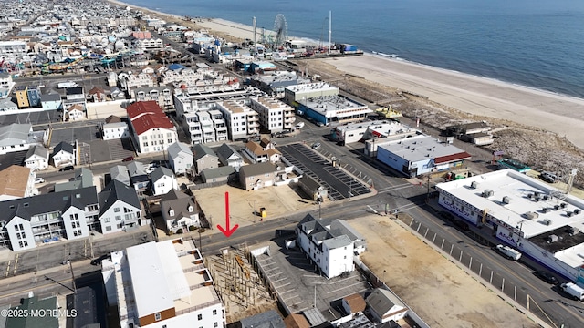 drone / aerial view featuring a view of the beach and a water view