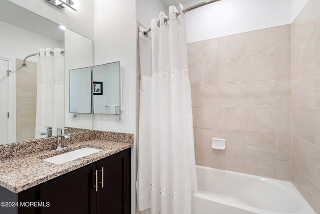 bathroom featuring shower / tub combo with curtain and vanity