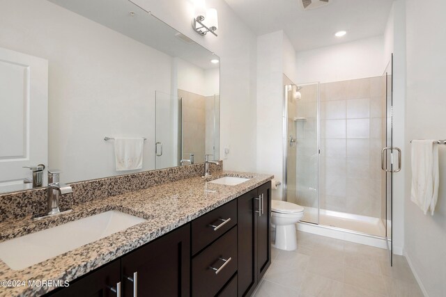 bathroom featuring vanity, tile patterned flooring, an enclosed shower, and toilet