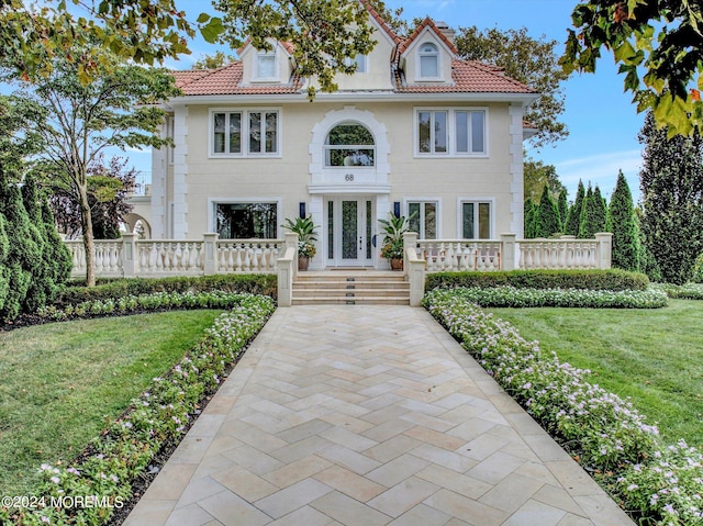 mediterranean / spanish house featuring a front yard