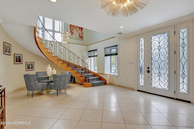 entryway with light tile patterned flooring and a chandelier