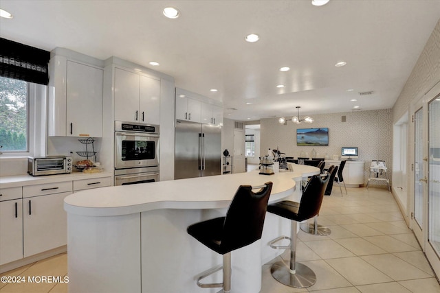 kitchen featuring white cabinets, appliances with stainless steel finishes, and a kitchen island