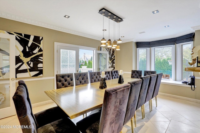 tiled dining space with ornamental molding, a wealth of natural light, and an inviting chandelier