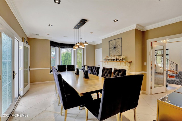 tiled dining space featuring a fireplace, crown molding, and a chandelier