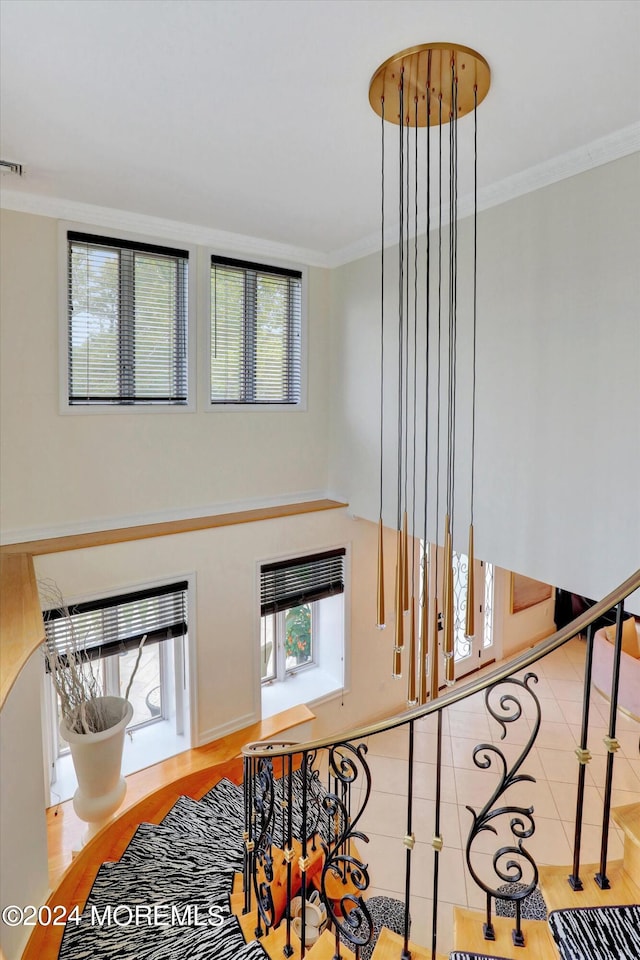 stairs featuring tile patterned flooring and ornamental molding