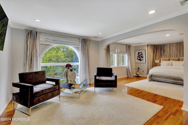 bedroom featuring crown molding and light hardwood / wood-style floors