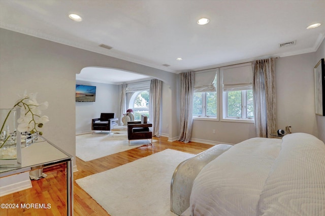 bedroom with light hardwood / wood-style flooring and ornamental molding