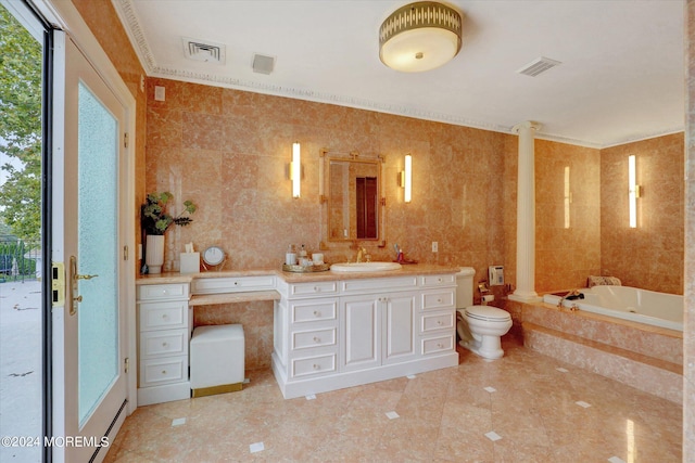 bathroom with tiled tub, vanity, tile walls, and toilet