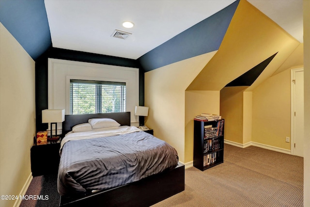 bedroom featuring lofted ceiling and carpet flooring